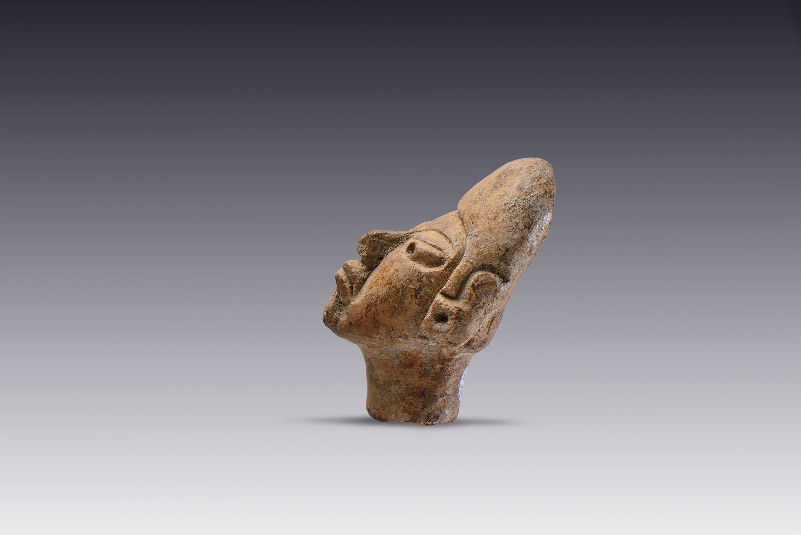 Cabeza masculina con tocado tipo casco y orejeras  | El M&eacute;xico antiguo. Salas de Arte Prehisp&aacute;nico | Museo Amparo, Puebla